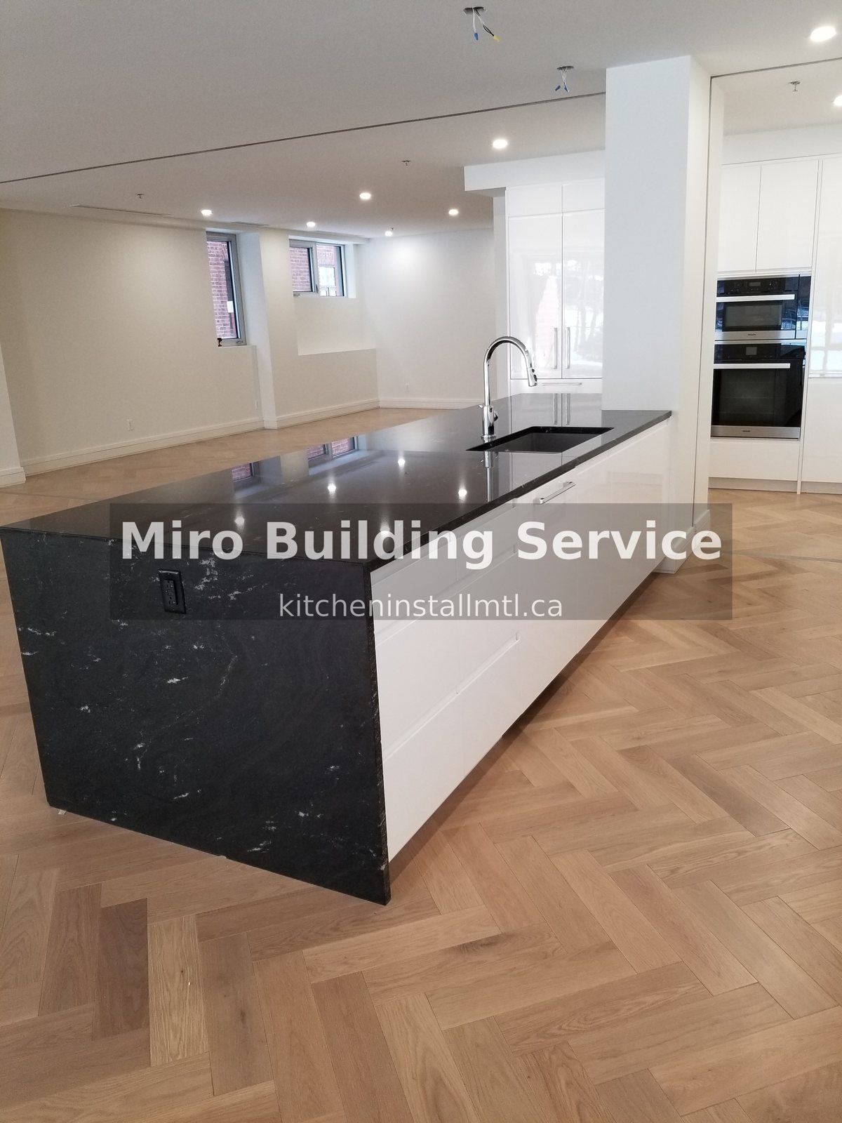 Custom lacquered white gloss kitchen black marble island